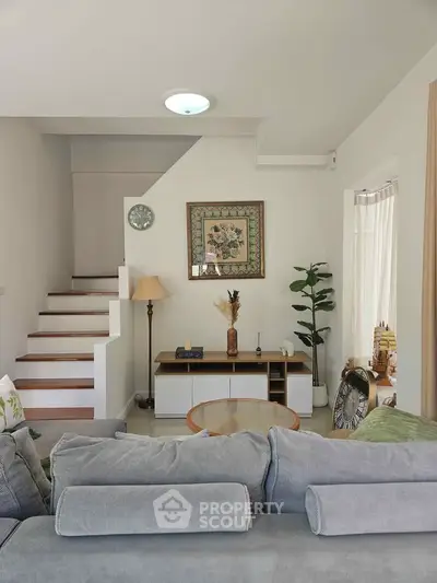 Charming living room with cozy sofa and elegant decor, perfect for relaxation and entertaining.