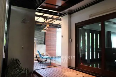 Luxurious indoor-outdoor living space with modern design and elegant wooden flooring.