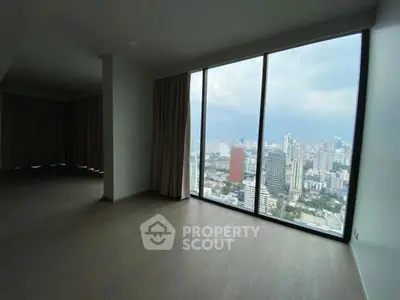 Spacious apartment with stunning city view from floor-to-ceiling windows.