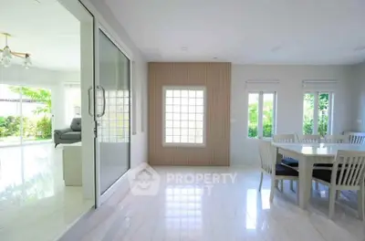 Spacious dining area with natural light and garden view in modern home