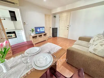 Cozy living room with dining area and kitchen view, perfect for modern living.