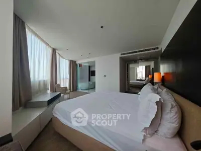 Spacious modern bedroom with large windows and elegant decor