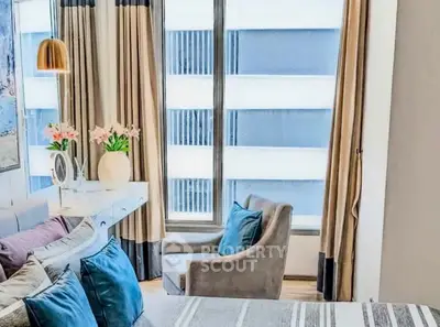 Chic bedroom with modern decor and large window offering city views