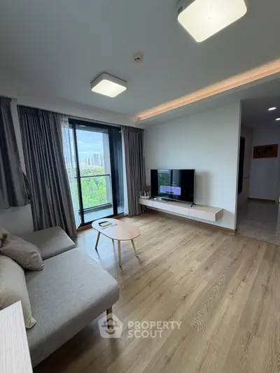 Modern living room with sleek furniture and large window offering a stunning view.