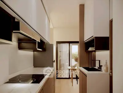 Modern kitchen with sleek design and open layout leading to dining area.