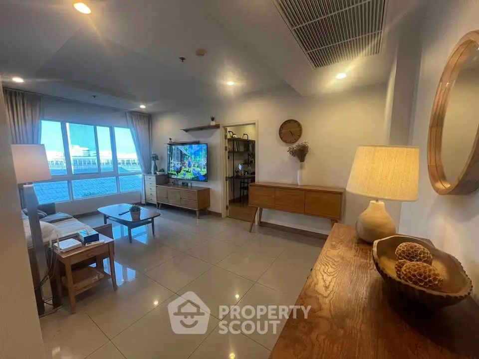 Spacious living room with modern decor and large windows offering a stunning view.
