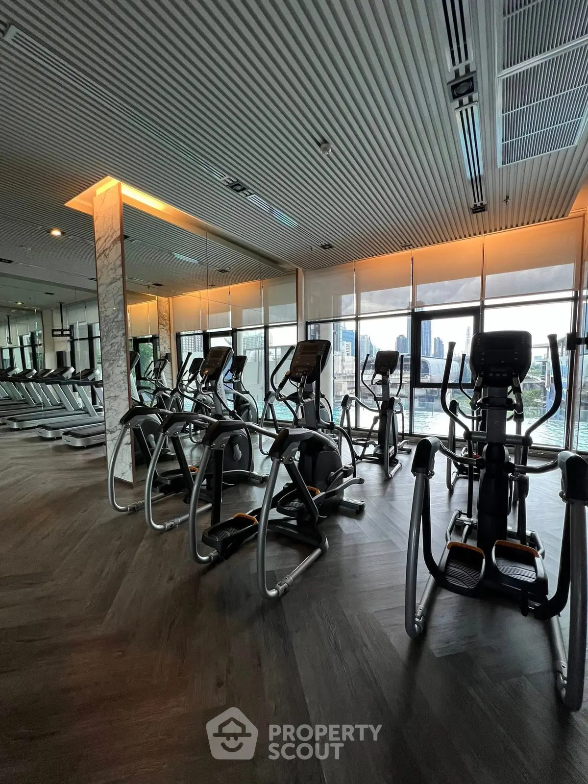 Modern gym with city view and state-of-the-art fitness equipment