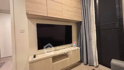 Modern living room with sleek TV setup and stylish cabinetry