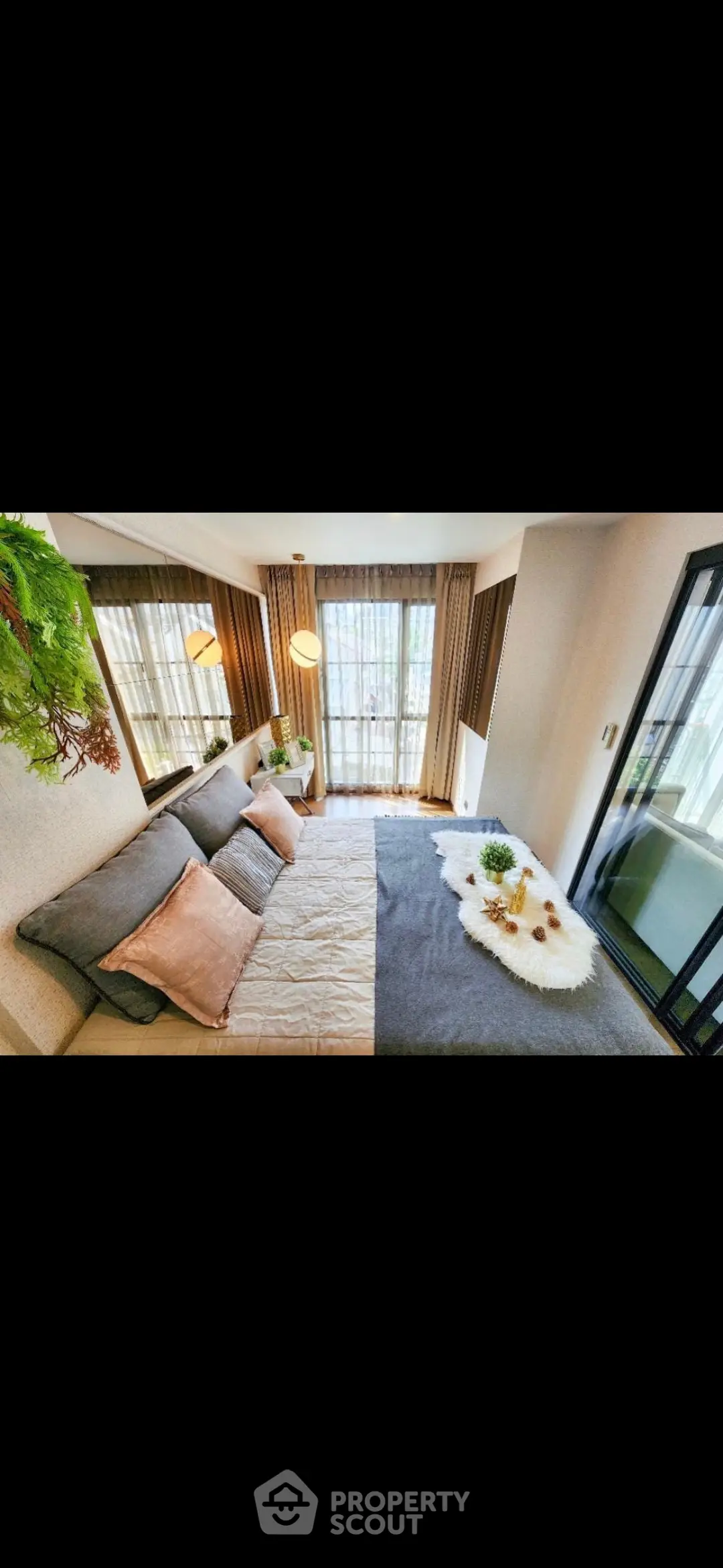 Luxurious bedroom with large windows and elegant decor, perfect for relaxation and comfort.
