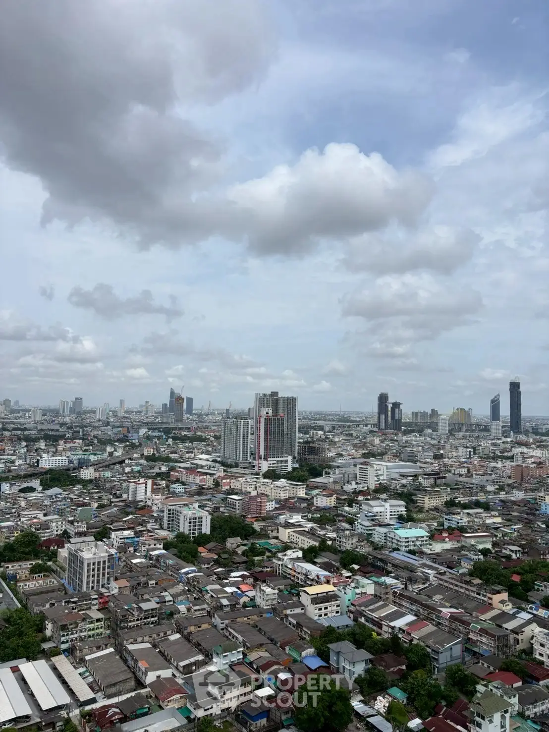 Stunning cityscape view showcasing urban skyline with high-rise buildings under a cloudy sky.