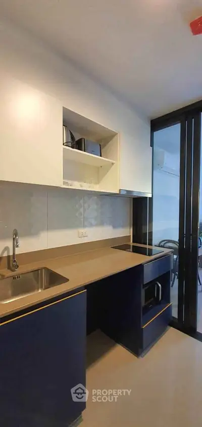 Modern kitchen with sleek design and open layout, featuring built-in appliances and stylish cabinetry.