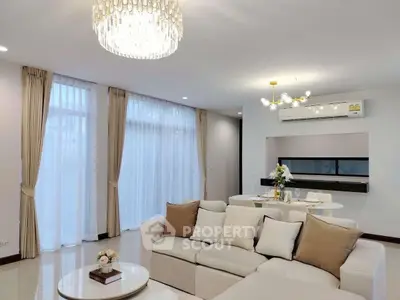 Elegant living room with modern decor and large windows