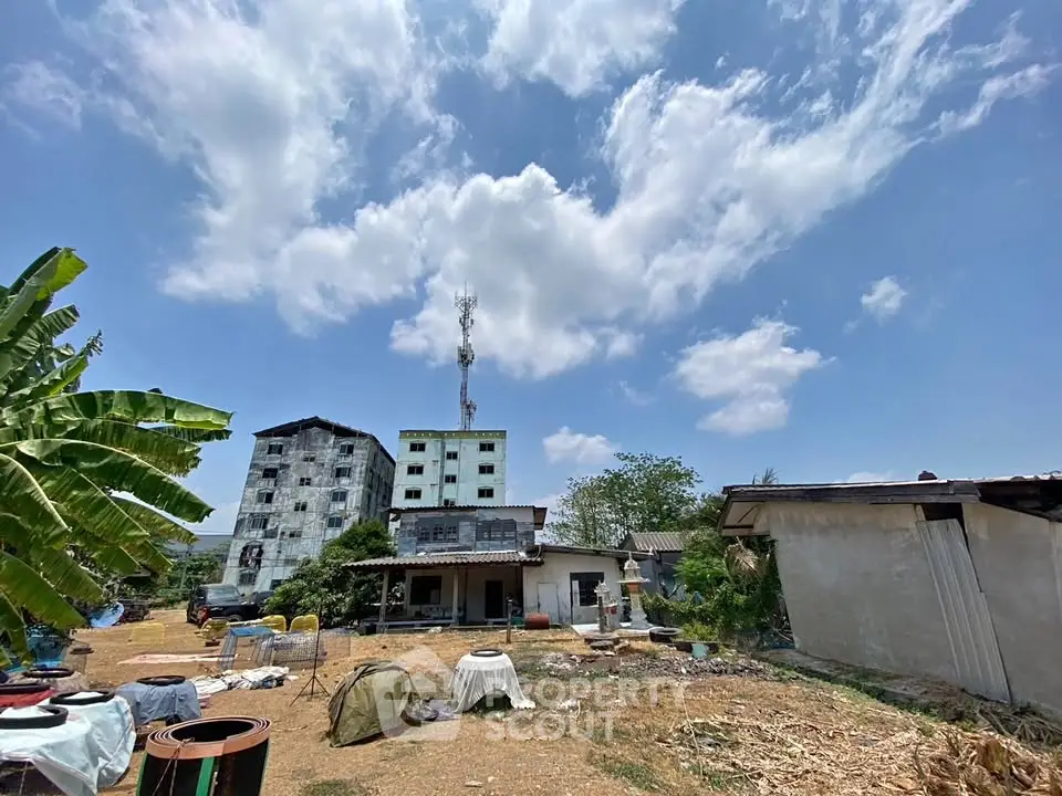 Explore this unique rural property with expansive outdoor space and potential for development under a clear blue sky.