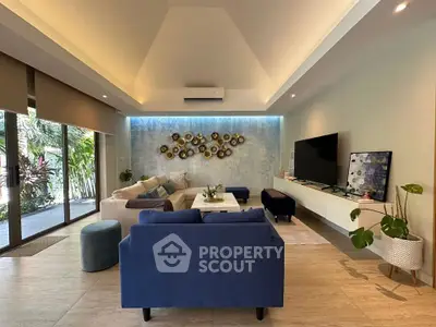 Luxurious living room with modern decor, spacious seating, and large windows overlooking a lush garden.