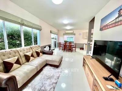Spacious living room with modern decor and large windows for natural light