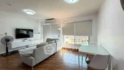 Modern living room with sleek furniture and large windows for natural light.