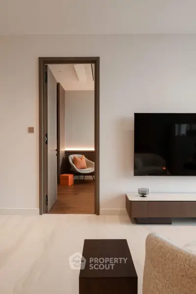 Modern living room with sleek TV setup and cozy seating area, perfect for relaxation and entertainment.