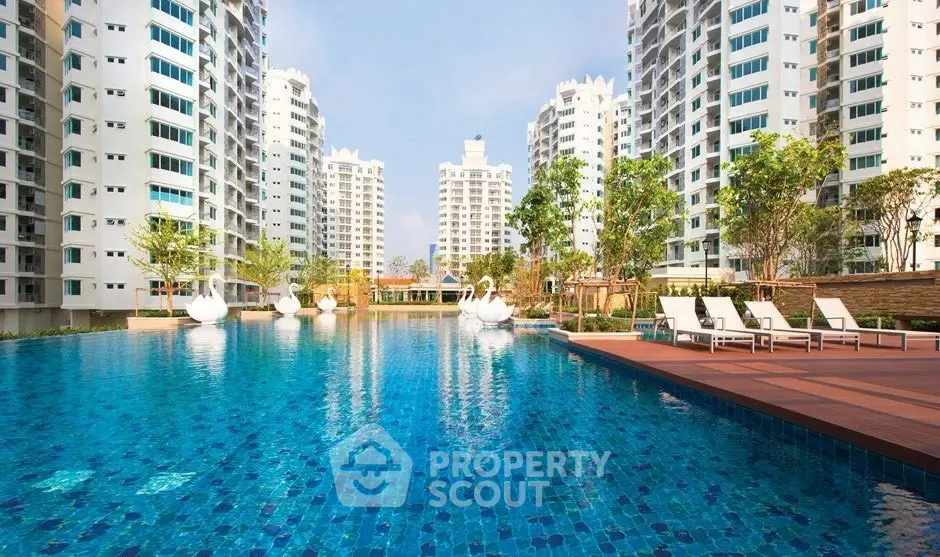 Luxurious residential complex with stunning pool and modern high-rise buildings.
