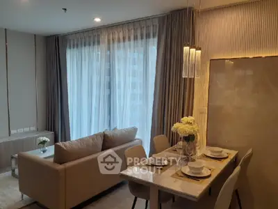 Elegant modern living room with dining area and large windows in luxury apartment