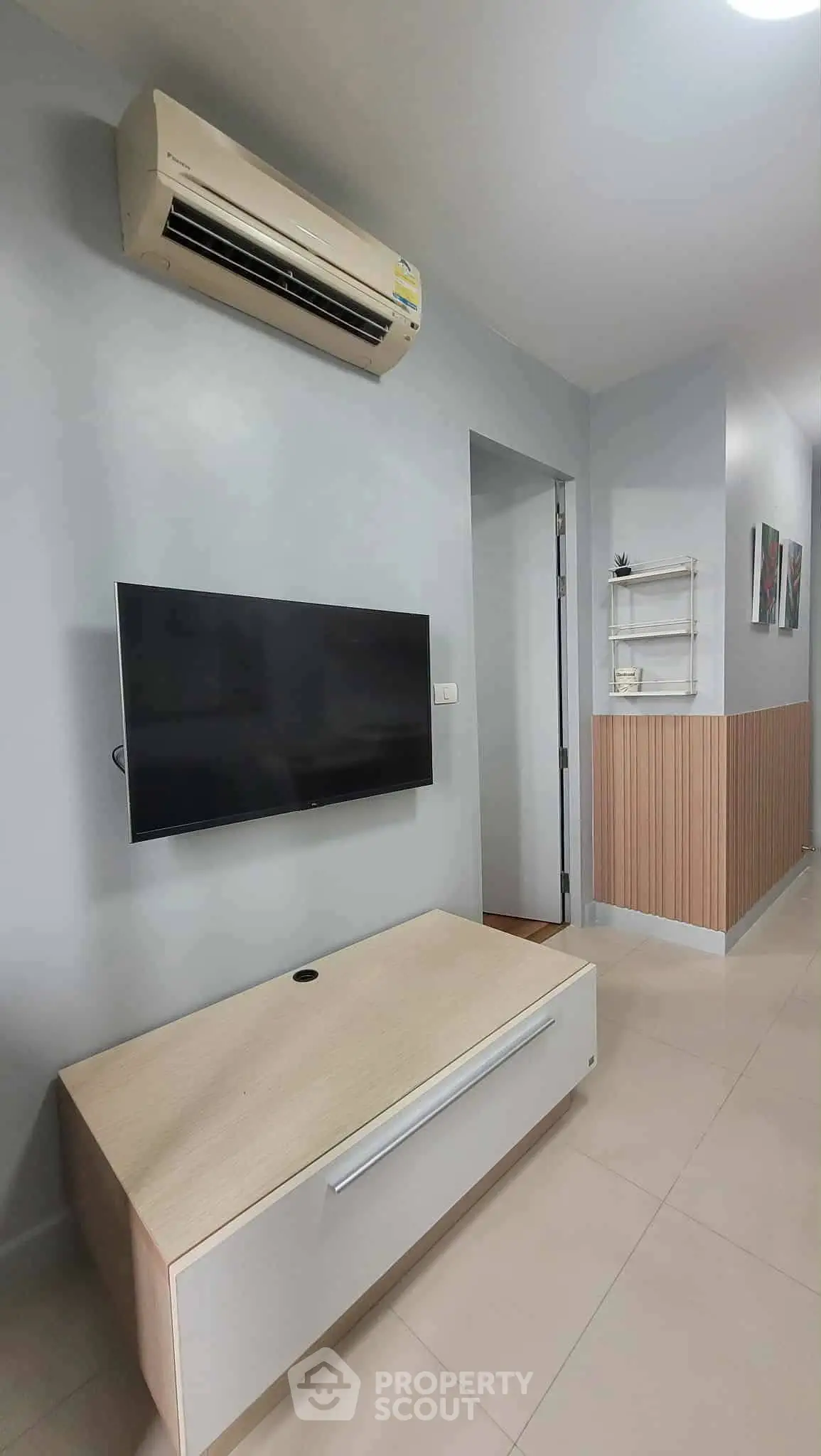 Modern living room with wall-mounted TV and air conditioning unit