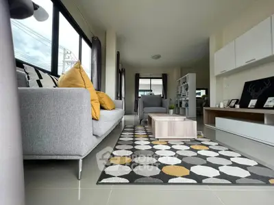 Modern living room with stylish decor and large windows