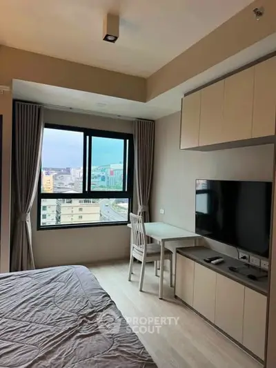 Modern bedroom with city view, featuring sleek furniture and a wall-mounted TV, perfect for urban living.