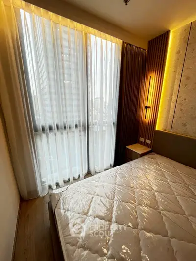 Cozy bedroom with large window and modern lighting