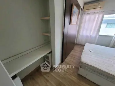 Cozy bedroom with natural light and built-in storage, perfect for modern living.