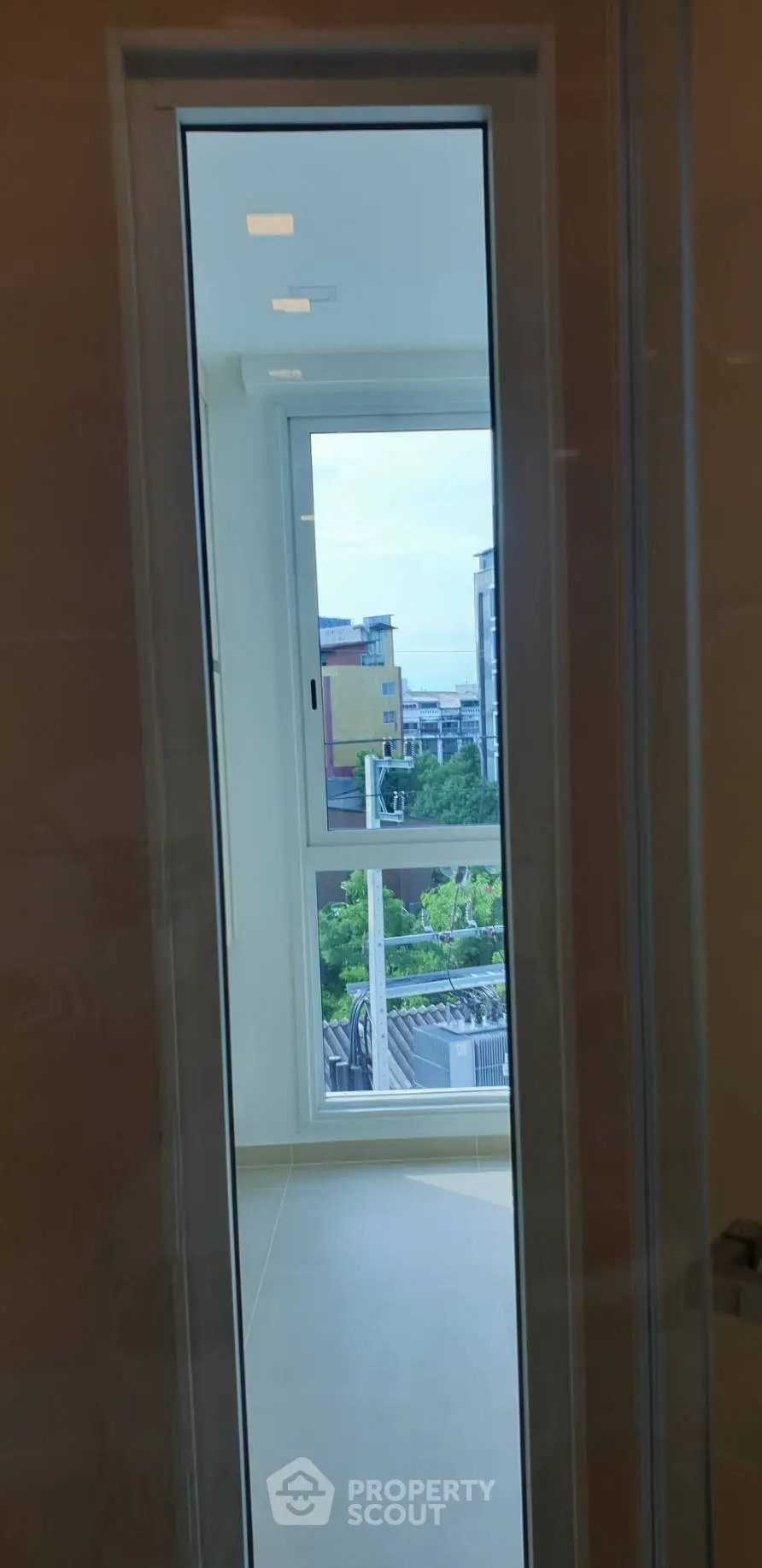 Modern apartment window with city view and natural light