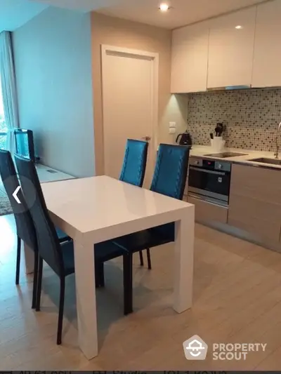 Modern kitchen with sleek dining area and stylish backsplash