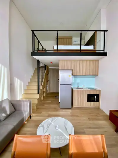 Modern loft apartment with mezzanine bedroom, stylish kitchen, and cozy living area.