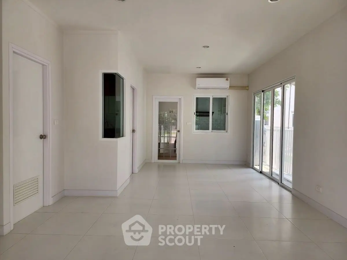 Spacious modern living room with large windows and air conditioning