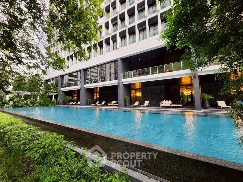 Luxurious apartment building with stunning pool and lush greenery