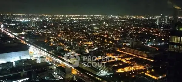 Stunning cityscape night view from high-rise building showcasing vibrant urban lights.