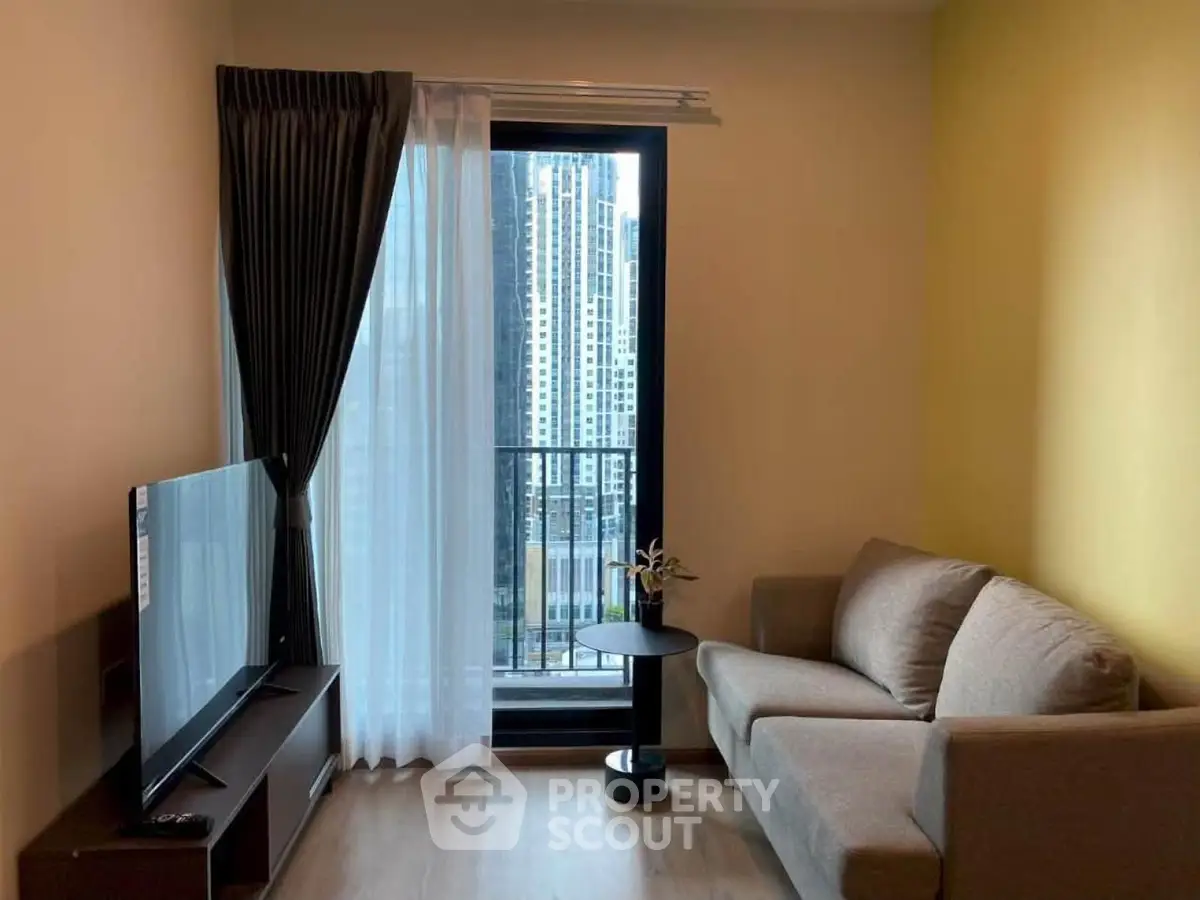 Modern living room with city view, cozy sofa, and large TV, perfect for urban living.