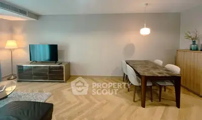 Modern living room with stylish dining area and elegant wooden flooring