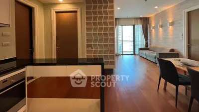Spacious modern living room with open kitchen and elegant wooden flooring