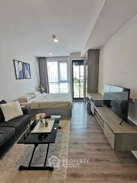 Modern studio apartment with stylish decor and large windows