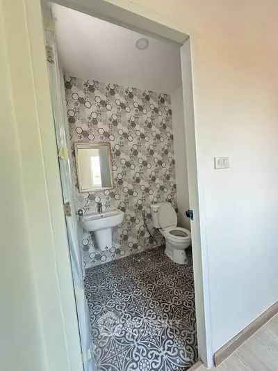 Modern bathroom with stylish patterned tiles and sleek fixtures