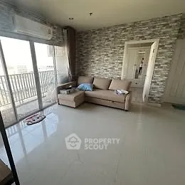 Spacious living room with modern decor and balcony access