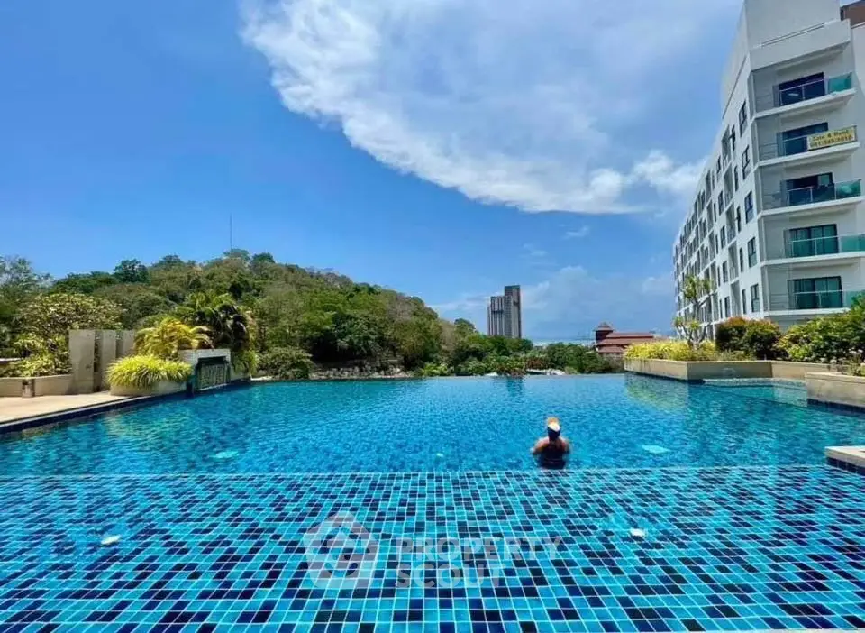 Luxurious apartment complex with stunning infinity pool and scenic views.