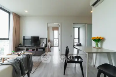 Modern living room with sleek furniture and natural light, perfect for urban living.