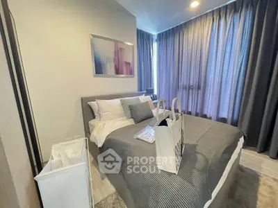 Modern bedroom with stylish decor and large windows in a contemporary apartment.