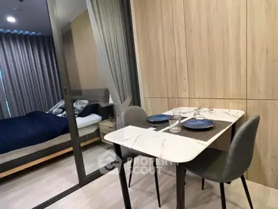 Modern apartment interior with cozy dining area and view into stylish bedroom