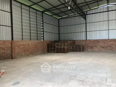 Spacious industrial warehouse with brick walls and metal roofing