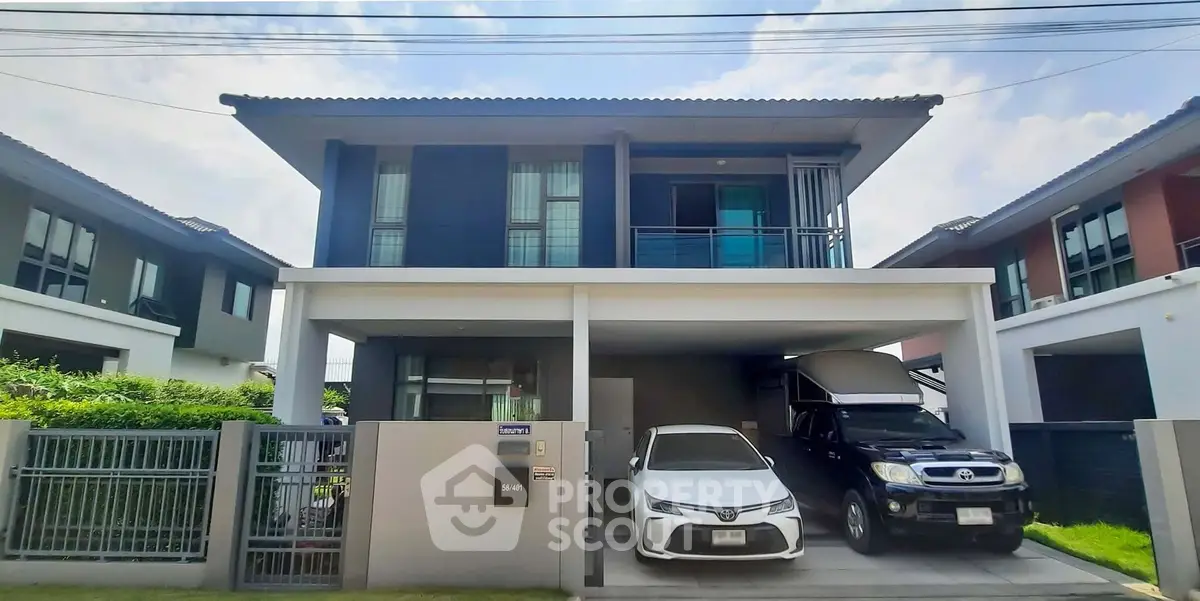 Modern two-story house with carport and sleek design in a suburban neighborhood.