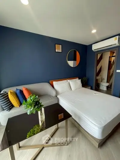 Modern bedroom with stylish decor and cozy seating area