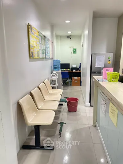 Modern office reception area with seating and water dispenser