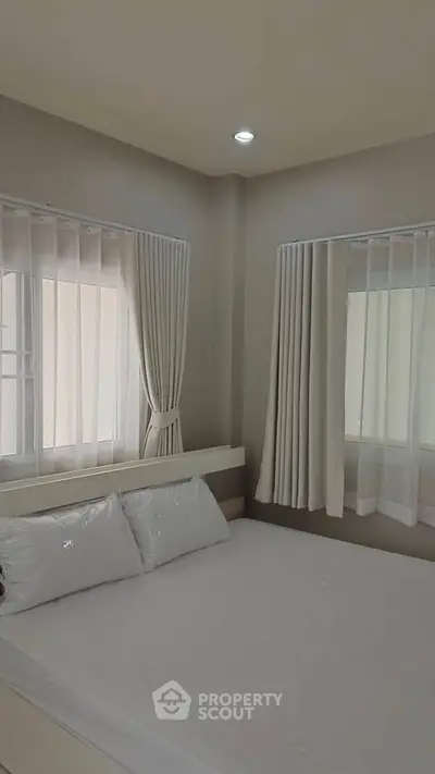 Cozy bedroom with natural light and elegant curtains