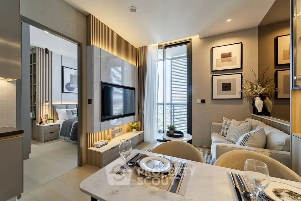 Modern living room with elegant decor and open view to bedroom, featuring stylish furniture and wall art.